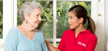 A happy senior and a caring healthcare worker